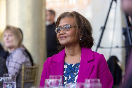 Dr. Elaine Batchlor, a middle-aged Black woman, seated at The Dream Lunch